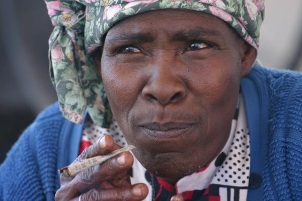 nama woman smoking in kalahari desert