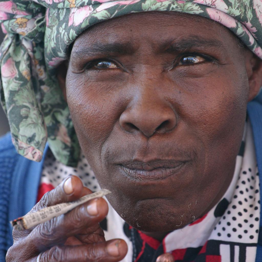 nama woman smoking in kalahari desert