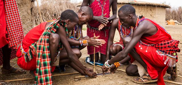 maasai men trying to start a fire tanzania kenya