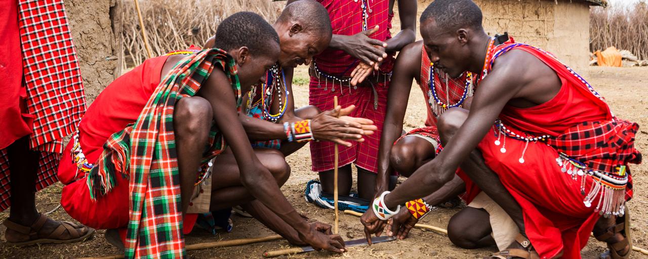 maasai men trying to start a fire tanzania kenya