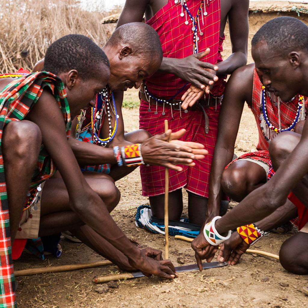 maasai men trying to start a fire tanzania kenya